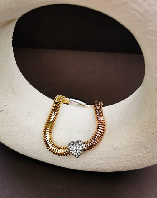 Gold tone bracelet with crystal heart detail